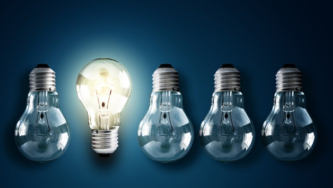 Illuminated light bulb in a row of dim ones concept for creativi